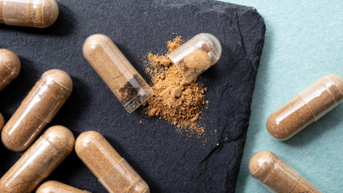 Herbal powder spilling from an open capsule — know exactly what goes into every supplement you make.