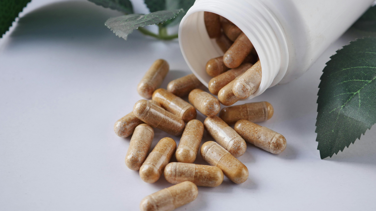 Homemade magnesium glycinate capsules poured out for supplement dosing