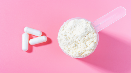 White capsules and magnesium glycinate powder in a scoop, showing how DIY supplement capsules are filled at home.